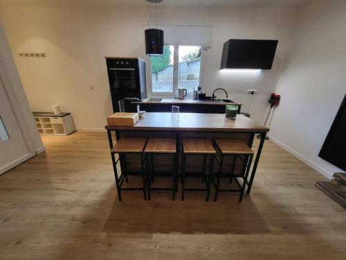 a kitchen with a table and a sink in a room at Appartement T2 Frangy in Frangy