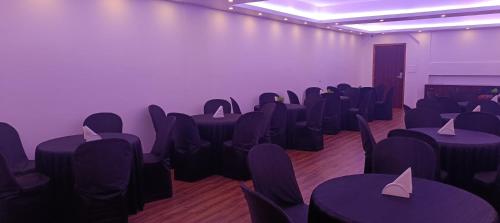 a conference room with purple tables and chairs at XCELSIOR HOTEL AND SPA by ROH in Shillong