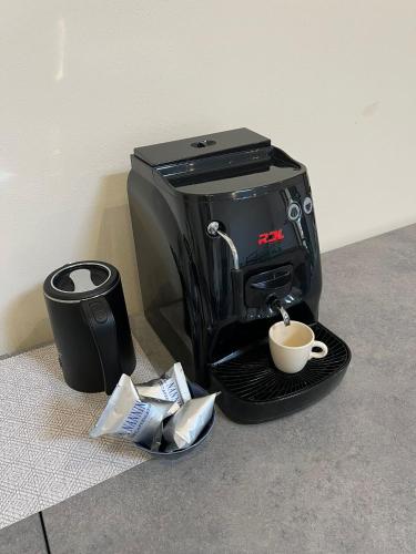 a coffee maker with a cup of coffee on a tray at Affittacamere Podere Valserena in Monteroni dʼArbia