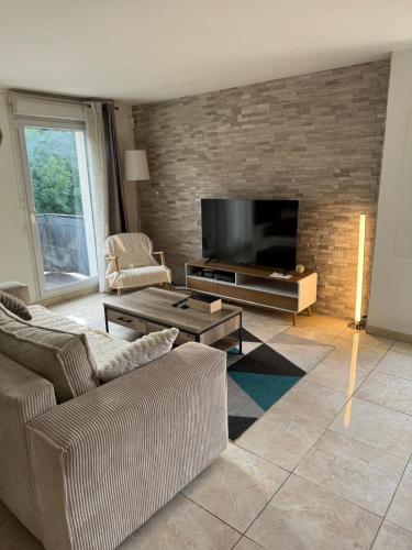 a living room with two couches and a flat screen tv at Appartement duplex T3 avec box - Paris - La Défense - Airport CDG - Parc des expositions - Stade de France - Disney - Astérix - Val D Europe in Villepinte