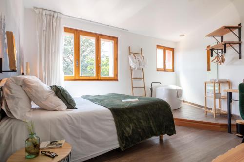 a bedroom with a bed and a window at Hotel Restaurant Les Glycines in Vieille-Brioude