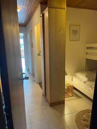 a room with a bedroom with a bed and a hallway at Appartement Concorde MoonTain - Face aux pistes - Central in L'Alpe-d'Huez