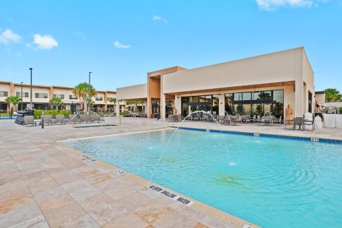 a swimming pool in front of a building at MAGIC VILLAGE - Near Disney - 4BDR in Orlando