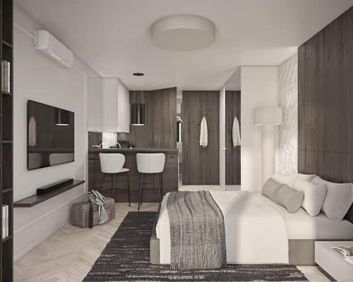 クラクフにあるPrestiżowy apartament A free parkingの大きな白いベッドとキッチンのある寝室