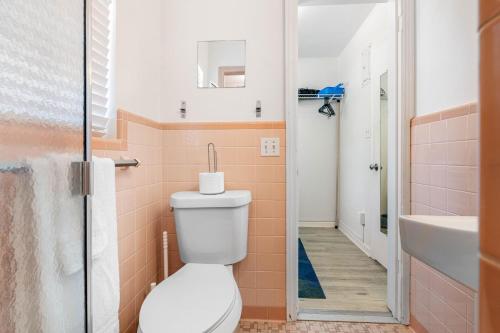 a bathroom with a toilet and a sink at St Pete Boho Getaway Walk to Pier and Beach in St. Petersburg