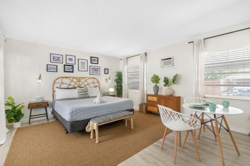 a bedroom with a bed and a table and chairs at St Pete Boho Getaway Walk to Pier and Beach in St. Petersburg