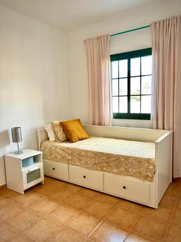 a bedroom with a large bed with a window at Casa Pepe Las Candelarias in Agaete