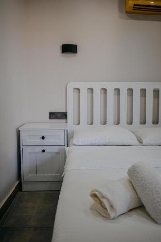 a bedroom with two white beds and a nightstand at La Sorella in Dalyan