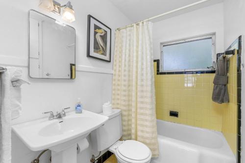 a bathroom with a sink and a toilet and a window at Perfect Location Vinoy Beach Getaway Sun and fun in St. Petersburg