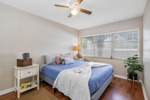 a bedroom with a blue bed and a ceiling fan at Perfect Location Vinoy Beach Getaway Sun and fun in St. Petersburg
