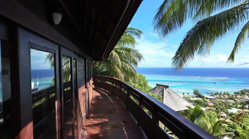 a balcony with a view of the ocean at MOOREA - Villa Ana Mua in Papetoai