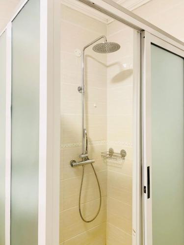 a shower with a glass door in a bathroom at Tevody Heights in Nairobi