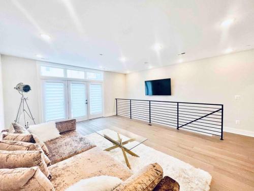 a living room with a couch and a flat screen tv at Luxurious 3BDR Penthouse with Private Rooftop Capitol and Monument Views Near Popular H Street Corridor Free Parking and Cancellation in Washington, D.C.
