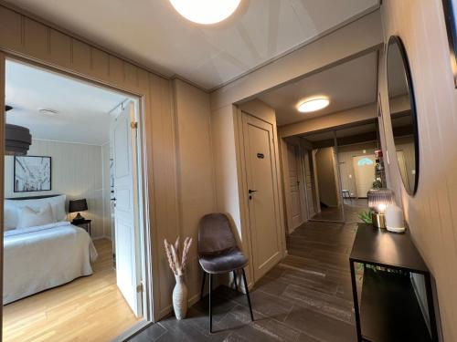 a bedroom with a bed and a desk and a television at Bratsberg Apartment - with Kitchenette and Free Parking in Trondheim