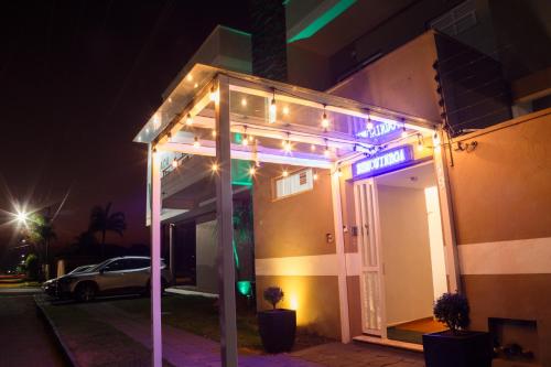 a sign on the side of a building with lights at Hotel e Pousada VIVÁ in Chapada dos Guimarães