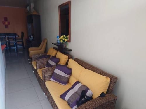 a living room with a couch with pillows on it at P H Claribel Piso 3 en Las Tablas al lado del Hotel Presidente in Las Tablas