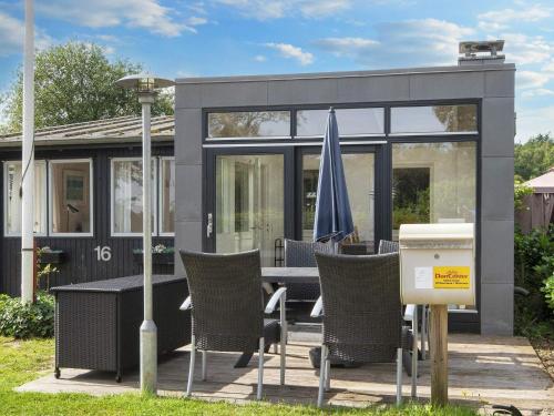 a house with a patio with a table and chairs at 6 person holiday home in Sjølund-By Traum in Sjølund