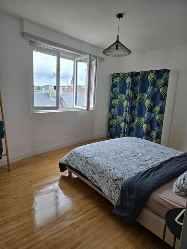 une chambre avec un lit et une fenêtre dans l'établissement Appartement vue sur château fort de Lourdes, à Lourdes