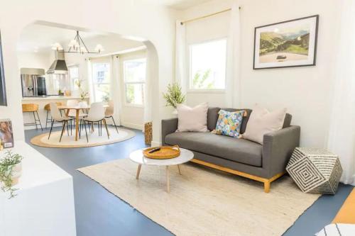 a living room with a couch and a table at Little Italy 3BD Home with Huge Patio & Backyard in San Diego
