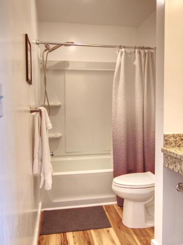 a bathroom with a shower and a toilet at Vermont Suites in South Burlington