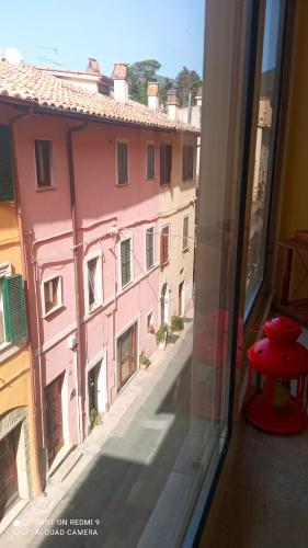 a view from a window of a pink building at Capital House- Casa Vacanze in Sabina in Poggio Mirteto