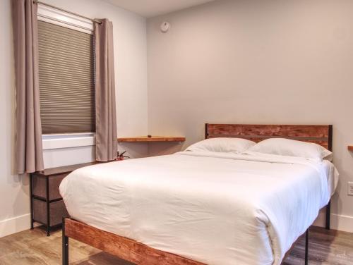 a bedroom with a large white bed with a window at Vermont Suites in South Burlington