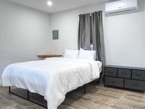 a bedroom with a large bed with white sheets at Vermont Suites in South Burlington