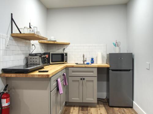 a kitchen with a sink and a refrigerator at Vermont Suites in South Burlington