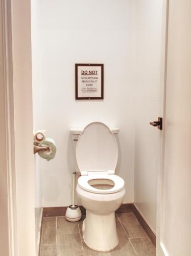 a bathroom with a toilet with a picture on the wall at Vermont Suites in South Burlington