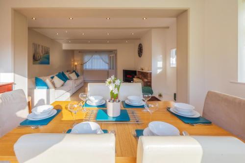 a dining room and living room with a table and chairs at The Secret Garden - West Sussex - 3BR House with Drive in Crawley