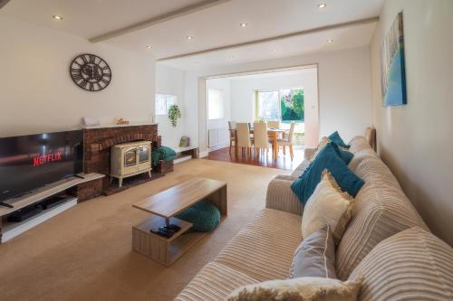 a living room with a couch and a tv at The Secret Garden - West Sussex - 3BR House with Drive in Crawley