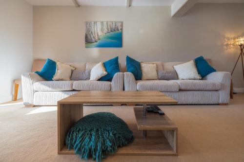 a living room with a couch and a coffee table at The Secret Garden - West Sussex - 3BR House with Drive in Crawley