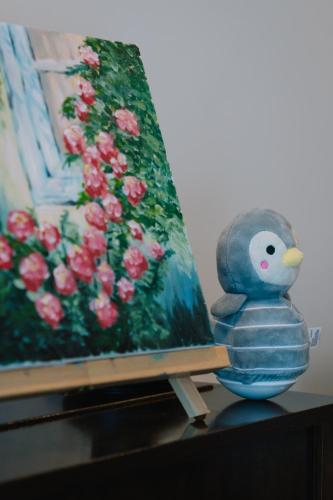 a stuffed teddy bear sitting next to a painting at breathtaking Fortitude valley Apartment in Brisbane