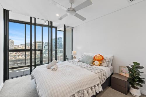 a bedroom with a bed and a large window at breathtaking Fortitude valley Apartment in Brisbane