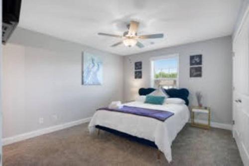 a bedroom with a bed and a ceiling fan at Luxury keyless free WiFi exit 11 in Clarksville