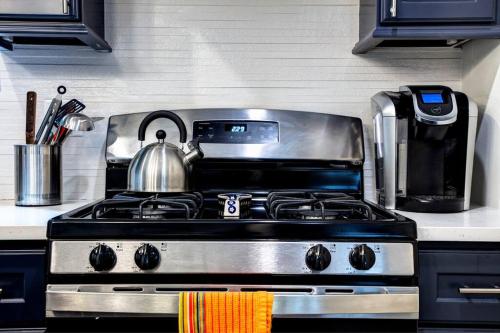 a kitchen stove with a tea kettle on top of it at Stylish 2BR stunner in unbeatable location in Chicago