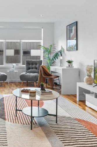 a living room with a couch and a table at Hidden Gem at Caulfield Park in Melbourne