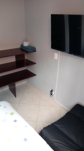 a room with a bed and a tv on a wall at HABITACIÓN, Suba, Bogotá in Bogotá