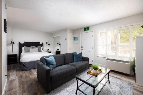 a living room with a couch and a bed at Studio Condo @ North Creek|Pool/Hot Tub/Crave TV in Blue Mountains