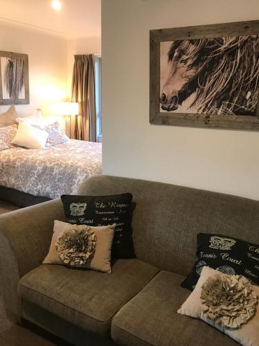 a living room with a couch and a bed at Arcadia in Pakipaki