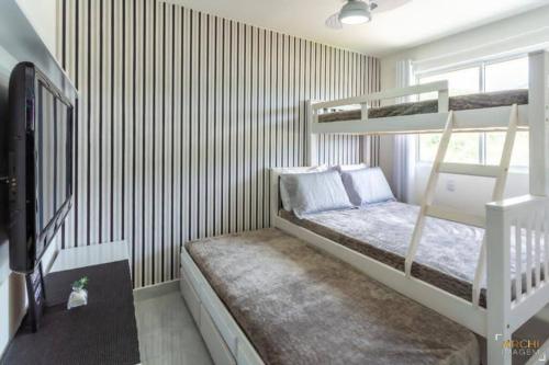 Ένα ή περισσότερα κρεβάτια σε δωμάτιο στο Apartamento em Itapema