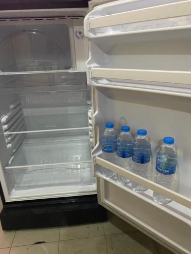 an open refrigerator with bottles of water in it at Saran Hotel krabi Thailand in Krabi