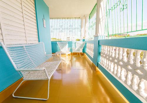 a waiting room with chairs and blue walls at Centrally Located Beach and Restaurant Centric in Cabo Rojo