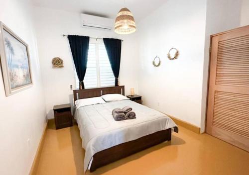 a bedroom with a bed with two towels on it at Centrally Located Beach and Restaurant Centric in Cabo Rojo