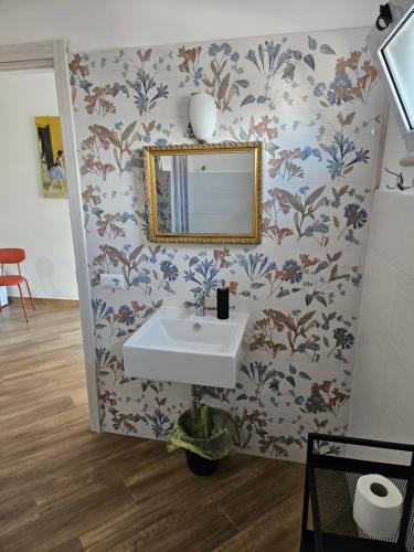a bathroom with a sink and a mirror at Onda Blu in Agropoli