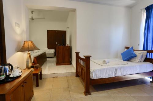 a bedroom with a bed and a bathroom at Mount Marina Villas 12 in Galle