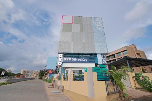 a building with a tower on top of it at Hotel O Nirsukh Palace in Navi Mumbai