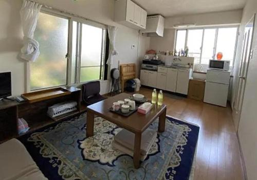 東京にあるTokyo downtown芍藥莊のコーヒーテーブルとキッチンのあるリビングルーム