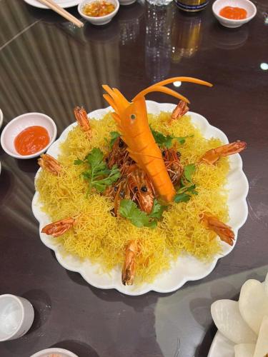 a plate of food with a carrot on top at TRA LINH HOTEL & RESTAURANTs in Hữu Lũng
