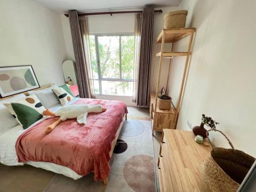 a bedroom with a large bed and a window at Self Check in 10min to BKKairport Train2Town Near Mall Local Market WIFI in Bangkok